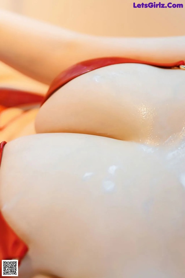 A close up of a woman's butt in a red bikini.