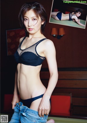 A woman in a white lingerie standing in front of a window.