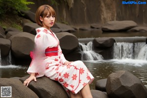 A woman in a long dress standing on a wooden floor.