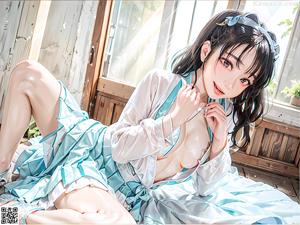 A woman in a kimono sitting on a bed.