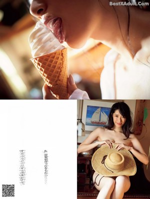 A woman in a white shirt eating an ice cream cone.