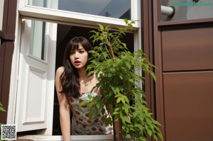 A woman sitting on a couch in front of a window.