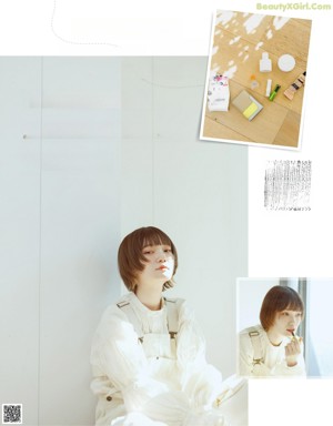a woman in a white shirt and white pants holding a brown bag