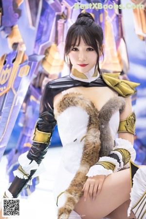 A woman dressed in a costume holding a sword.