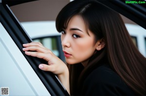 A woman with long brown hair is posing for a picture.